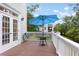 Relaxing deck area with a blue umbrella for shade and a table with seating provides the perfect outdoor space at 2293 Beckenham Dr, Mount Pleasant, SC 29466