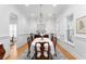Formal dining room with chandelier, neutral color palette, wainscoting and a view of the exterior at 2293 Beckenham Dr, Mount Pleasant, SC 29466