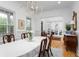 Bright dining room featuring a classic chandelier, fresh flowers, and ample natural light at 2293 Beckenham Dr, Mount Pleasant, SC 29466