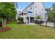 A charming exterior with a deck, lush lawn, and convenient access to a three-car garage at 2293 Beckenham Dr, Mount Pleasant, SC 29466