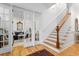 Bright entryway with wood floors, a staircase, white wainscoting and french doors to a living area at 2293 Beckenham Dr, Mount Pleasant, SC 29466
