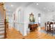 Bright hallway featuring hardwood floors, white walls, decorative accents and a staircase at 2293 Beckenham Dr, Mount Pleasant, SC 29466