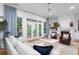 Bright living room with a cozy seating area, fireplace, and access to a balcony at 2293 Beckenham Dr, Mount Pleasant, SC 29466