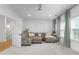 Open-concept living room boasts a large sectional sofa, ceiling fan and white walls at 2293 Beckenham Dr, Mount Pleasant, SC 29466