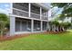 Inviting covered patio featuring comfortable swing seating for relaxing, with views of the well-manicured lawn at 2293 Beckenham Dr, Mount Pleasant, SC 29466