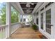 Cozy screened-in porch featuring a seating area with stylish decor and wooden floors at 2293 Beckenham Dr, Mount Pleasant, SC 29466