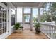 Inviting screened porch features wood flooring, plants and outdoor access at 2293 Beckenham Dr, Mount Pleasant, SC 29466