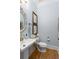 A quaint powder room with a gold faucet and decor offers charm and style at 2293 Beckenham Dr, Mount Pleasant, SC 29466