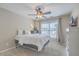 Bedroom with a white bedframe with comfortable bedding and a ceiling fan with light fixture above at 240 Mayfield Dr, Goose Creek, SC 29445