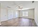 A spacious bedroom with three white doors, a ceiling fan with light and a window with blinds at 240 Mayfield Dr, Goose Creek, SC 29445