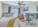 A bedroom with a bed and desk area, bathed in natural light from a window with blinds at 240 Mayfield Dr, Goose Creek, SC 29445