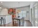 A dining area with a wooden table and chairs, with a view to the kitchen area at 240 Mayfield Dr, Goose Creek, SC 29445