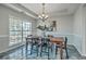 Elegant dining room with a large wooden table, six chairs, statement lighting, and decorative wall art at 240 Mayfield Dr, Goose Creek, SC 29445