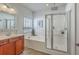A bright main bathroom with dual sinks, tub, and glass-enclosed shower at 240 Mayfield Dr, Goose Creek, SC 29445