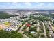 Aerial view of residential neighborhood featuring community pool, lush trees, and blue skies at 241 Kelsey Blvd, Wando, SC 29492