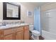 Bathroom with shower/tub combo, granite countertop and wood cabinets at 241 Kelsey Blvd, Wando, SC 29492