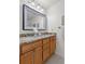 Bathroom featuring double sink vanity with granite countertops and framed mirror at 241 Kelsey Blvd, Wando, SC 29492