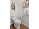 Powder room featuring toilet with wood flooring, artwork, and towel racks at 241 Kelsey Blvd, Wando, SC 29492