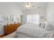 Bright bedroom features a ceiling fan, dresser, and doorway leading outside at 241 Kelsey Blvd, Wando, SC 29492