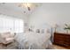 Light-filled bedroom with a plush bed, ceiling fan, and elegant decor at 241 Kelsey Blvd, Wando, SC 29492