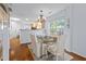 Elegant dining room features a glass-topped table, upholstered chairs, and a stylish chandelier at 241 Kelsey Blvd, Wando, SC 29492