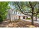 Charming two-story townhouse with a brick garage and gray siding, surrounded by lush trees at 241 Kelsey Blvd, Wando, SC 29492