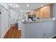 Bright kitchen featuring stainless steel appliances, granite countertops, and hardwood floors at 241 Kelsey Blvd, Wando, SC 29492
