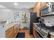 Bright kitchen with stainless steel appliances, granite countertops, and light wood cabinetry at 241 Kelsey Blvd, Wando, SC 29492