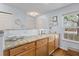 Bright kitchen featuring granite countertops, white backsplash, and natural light at 241 Kelsey Blvd, Wando, SC 29492