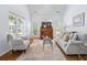 Sunlit living room with high ceilings, large windows, and stylish decor at 241 Kelsey Blvd, Wando, SC 29492