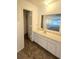 Bathroom vanity and closet with a large mirror and sink at 2494 Etiwan Ave # 9-D, Charleston, SC 29414