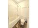 A full bathroom with a tub and shower, plus a toilet and linoleum wood flooring at 2494 Etiwan Ave # 9-D, Charleston, SC 29414