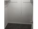 A walk-in closet with carpet and hanging racks at 2494 Etiwan Ave # 9-D, Charleston, SC 29414