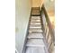 Carpeted stairway with painted risers and dark stained railing at 2494 Etiwan Ave # 9-D, Charleston, SC 29414