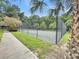 Fenced community tennis court with well-maintained court and surrounding greenery at 2494 Etiwan Ave # 9-D, Charleston, SC 29414