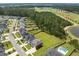 Aerial view of homes on a street with large backyard, tree line, and sports fields in the distance at 255 Saxony Loop, Summerville, SC 29486