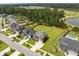 An aerial view of homes on a street with large backyard, tree line, and sports fields in the distance at 255 Saxony Loop, Summerville, SC 29486