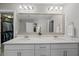 The bright bathroom features double sinks, granite countertop and a large mirror at 255 Saxony Loop, Summerville, SC 29486