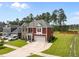 Two-story home boasts well-manicured landscaping, a two-car garage, and a classic brick facade at 255 Saxony Loop, Summerville, SC 29486