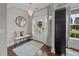 Bright foyer with elegant light fixture, wood floors, decorative mirror and entry to the home at 255 Saxony Loop, Summerville, SC 29486