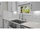 Bright kitchen features white cabinets, stainless steel sink and fixtures, quartz countertops, and a window at 255 Saxony Loop, Summerville, SC 29486