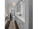 Bright kitchen featuring white cabinets, stone countertops and tiled backsplash adjacent to dining room at 255 Saxony Loop, Summerville, SC 29486