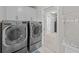 Spacious laundry room with updated washer and dryer, and built-in cabinets at 255 Saxony Loop, Summerville, SC 29486