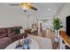 Open concept living room with brown leather sofa, decorative pillows, and view to the kitchen at 255 Saxony Loop, Summerville, SC 29486