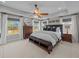 A beautifully staged primary bedroom features tray ceilings, lots of natural light and warm wood accents at 255 Saxony Loop, Summerville, SC 29486