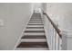 Staircase with wood treads, white risers, wood handrail, and a chandelier at 255 Saxony Loop, Summerville, SC 29486