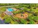 Overhead view of a community pool, playground, and green spaces surrounded by lush landscaping at 2582 Kingsfield St, Mount Pleasant, SC 29466