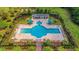 Aerial view of a community pool and lounge area surrounded by lush landscaping and palm trees at 2582 Kingsfield St, Mount Pleasant, SC 29466