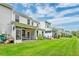 Wide shot of a green backyard featuring a screened-in porch and a well-maintained lawn at 2582 Kingsfield St, Mount Pleasant, SC 29466