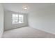 A vacant bedroom with a large window provides natural light and carpet at 2582 Kingsfield St, Mount Pleasant, SC 29466